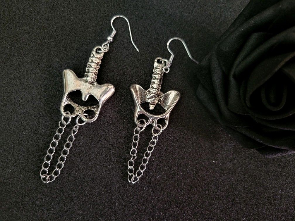 pelvic spine earrings, art by Sherrie Thai of Shaireproductions.com