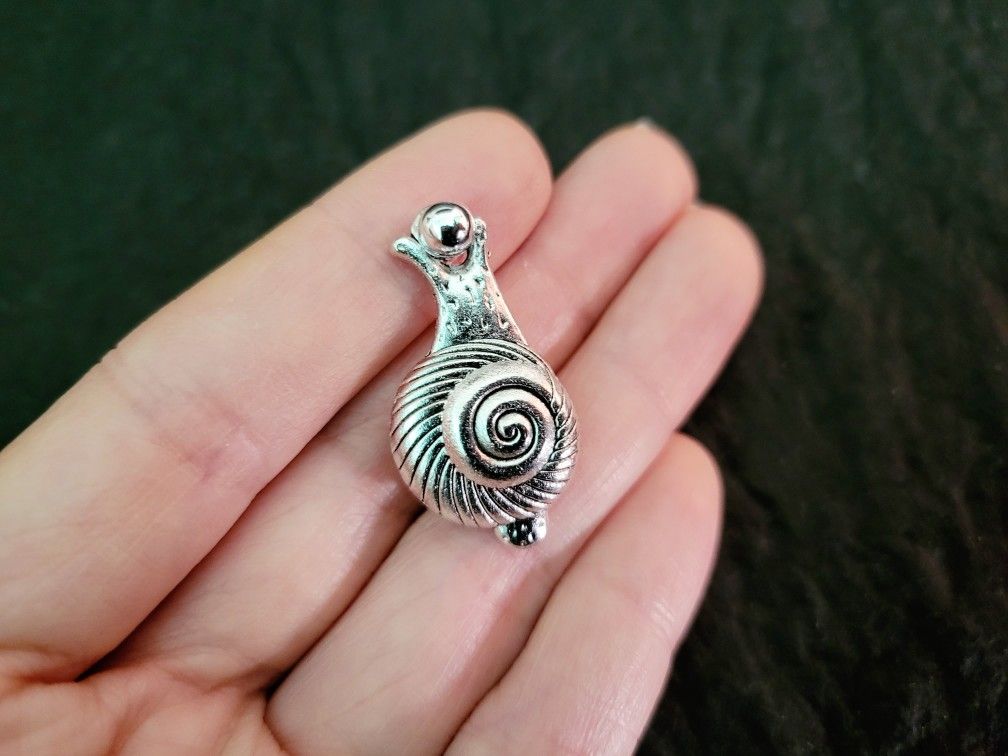 snail pin 2, art by Sherrie Thai of Shaireproductions.com