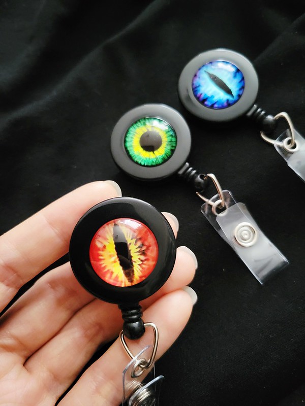 eyeball badge reels, art by sherrie thai of shaireproductions